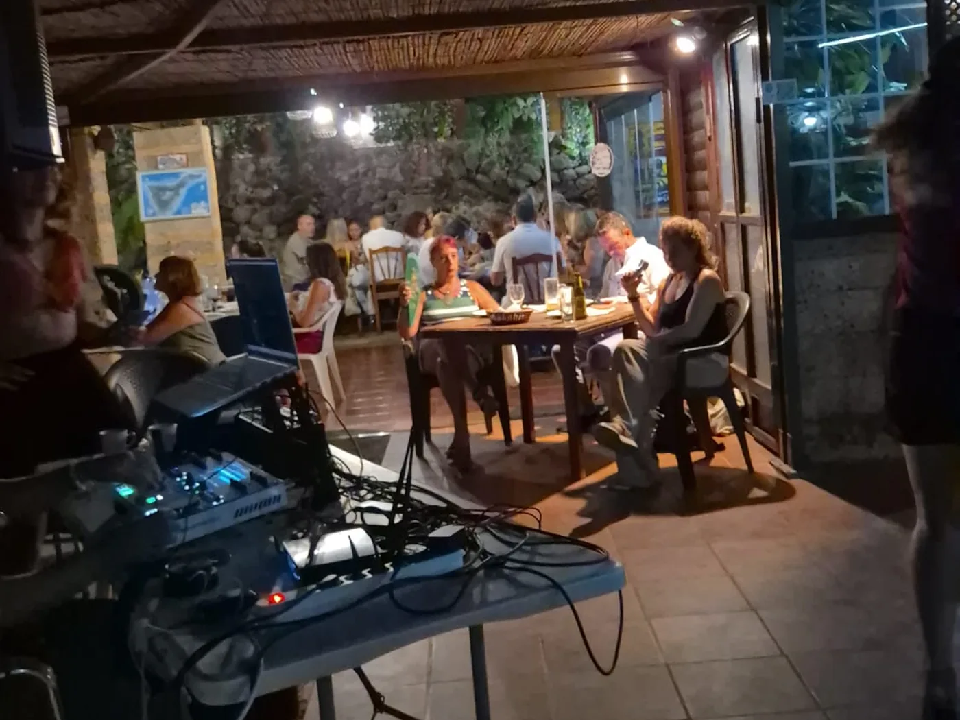 La cabina del DJ y las mesas ocupadas bajo el techo de caña, en una noche de Guachin Salsa